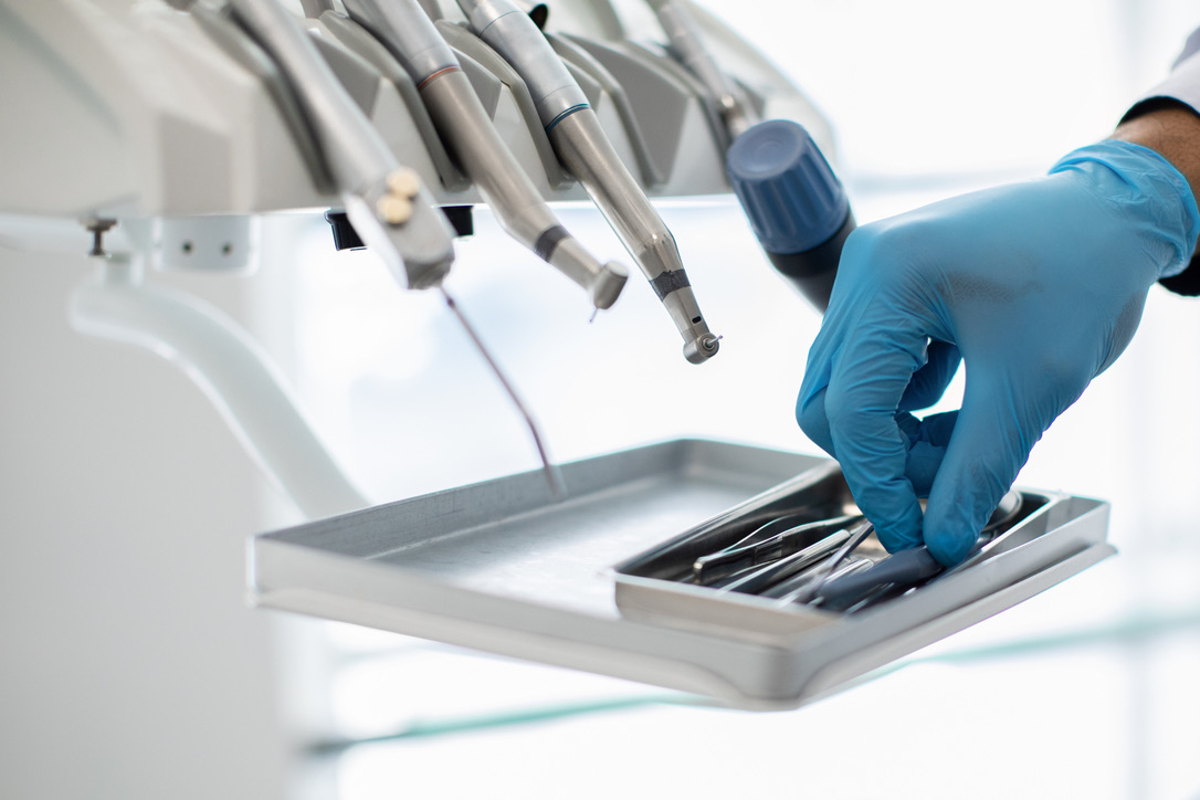 Closeup Shot Of Dentists Hand In Blue Glove Taking Sterile Stomatological Tools